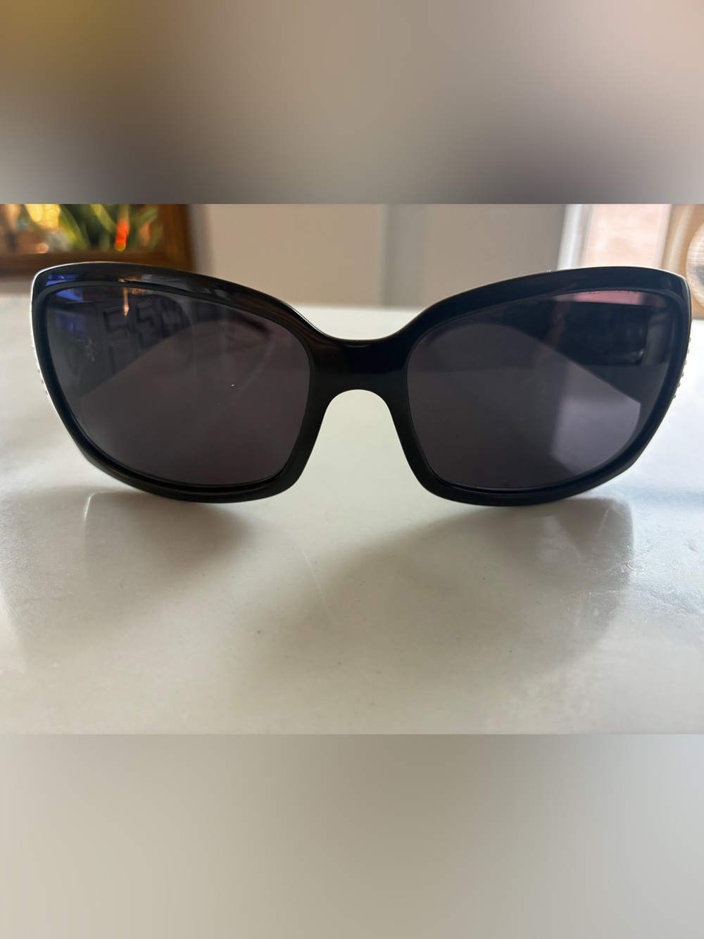 Fendi sleek sunglasses with Swarovski crystals embedded in logo.